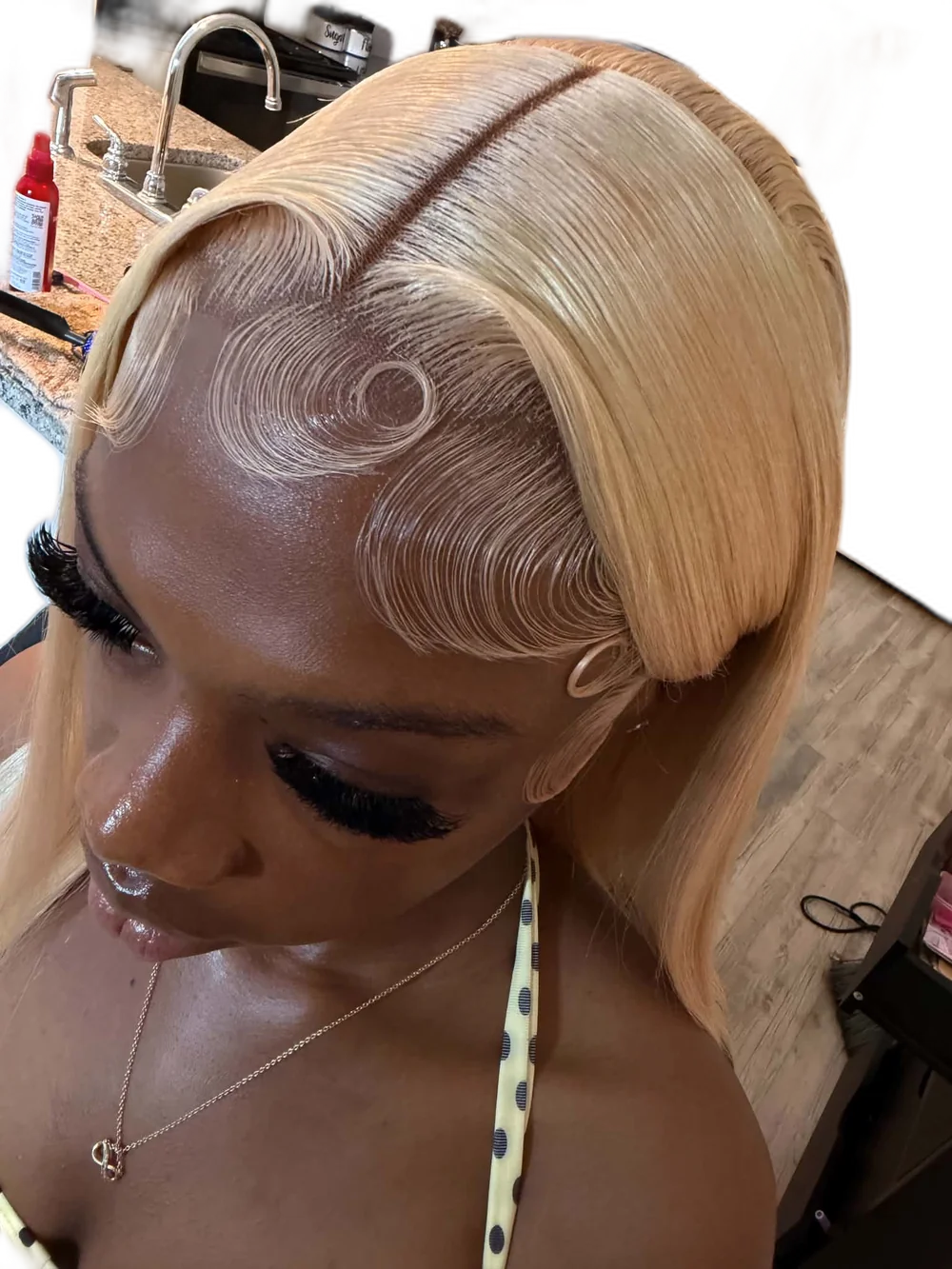 Sleek blonde bob lace install by HairByNiyia